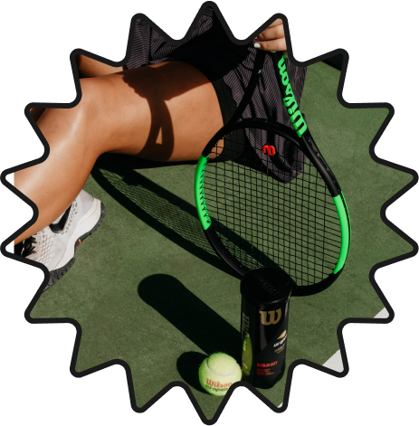 Tennis player sitting down on the court with tennis racket